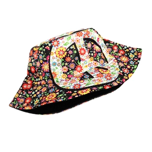 Detail of colorful floral pattern print on reversible black cotton fisherman bucket hat