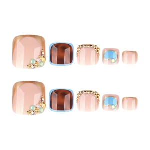 Sparkling rhinestone toe nail set featuring nude pink glitter and gemstone accents