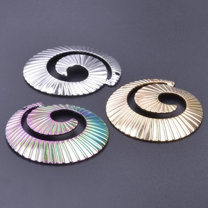 Macro detail of 18k gold and rainbow spiral screw pendants with grooved texture