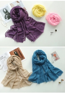 Detailed view of layered cotton linen scarves with fringe edges in vibrant summer colors
