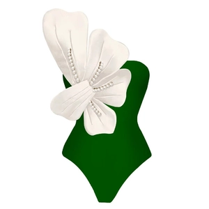 Detail of 3D white flower with pearls on a dark green one-shoulder swimsuit