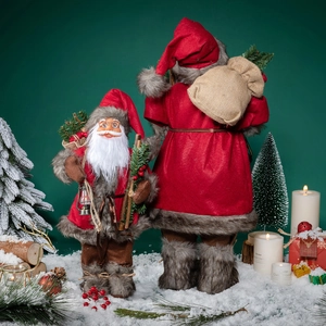 Standing Santa Claus plush doll set with red and brown outfits on snowy backdrop