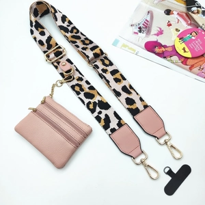 Detailed view of leopard print wide strap and detachable pink coin purse with metal clips