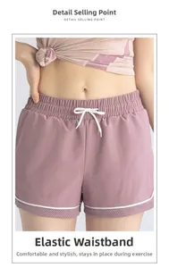 Detail of high-waisted pink sports shorts with elastic drawstring and mesh panels