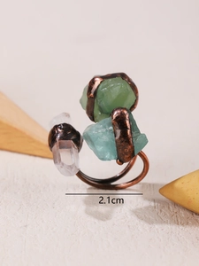 Macro detail of handmade punk ring with raw fluorite, aquamarine and white crystal stones