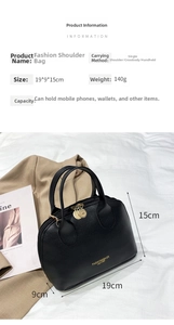 Detail view of black Boston bag with gold zipper and dimensions 19x9x15cm