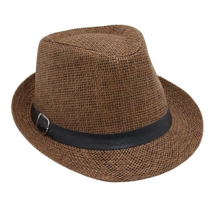 Detail of a brown straw fedora featuring a black faux leather band and silver metal buckle