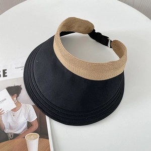 Top view of a wide brim sun visor hat with straw texture and adjustable buckle strap