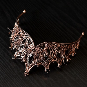 Detail of vintage Gothic bronze crown with black gemstones and intricate filigree work