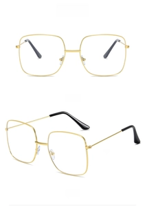 Detail of gold metal square frame glasses with slim temples and black ear tips