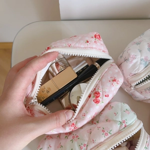 Detailed interior of the pink floral quilted cotton pouch showing storage capacity