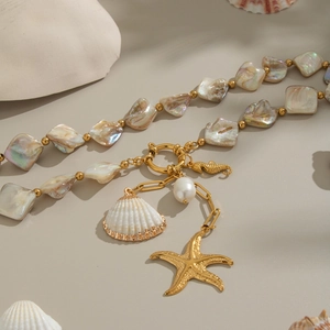 Gold ocean necklace with natural shells, pearls, and starfish on iridescent beads