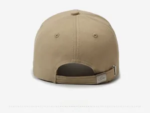Close-up of khaki cotton baseball cap with adjustable metal buckle and polo concept engraving
