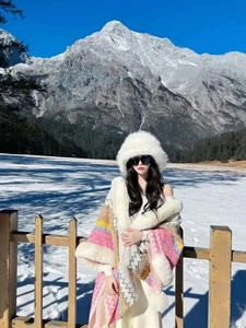 Detailed knit pattern and faux rabbit fur trim on a bohemian ethnic style winter poncho