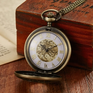 Detailed macro view of an open vintage bronze pocket watch showing mechanical dial gears