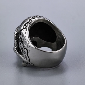 Detailed macro shot of vintage stainless steel skull ring with aged silver texture
