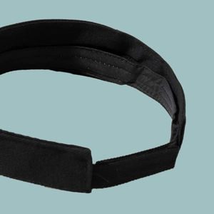Detail of black sun visor hat inner lining with sweatband and adjustable velcro closure