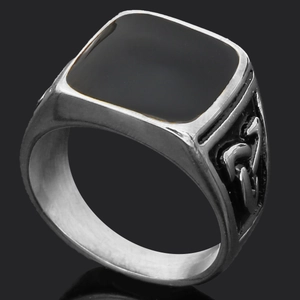 Detail view of vintage Thor's Hammer ring with black enamel face and engraved runes