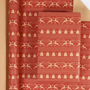 Macro detail of red Christmas wrapping paper with reindeer and snowflake kraft patterns