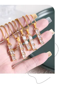 Detail of five gold necklaces with triple stacked rectangular zircon crystal pendants