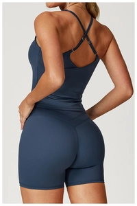 Macro detail of the cross-back straps and V-shaped seam on blue yoga shorts