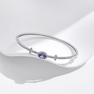 Elegant s925 silver bangle featuring a brilliant oval purple gemstone and pavé diamonds