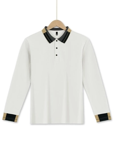 Detail view of white waffle polo shirt with striped black and gold collar and cuffs