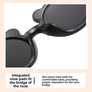 Close-up of integrated bear-shaped nose pads on matte black kids sunglasses