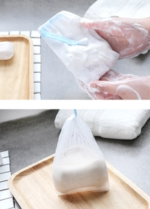 Close-up of double-layered nylon soap foaming net with blue drawstring and fine lather