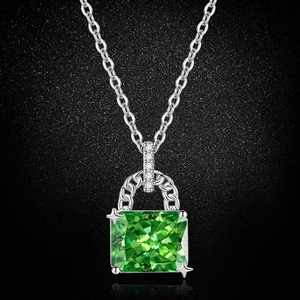 Detailed macro view of the faceted square green gemstone pendant on a silver chain