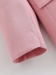 Close-up of pink casual blazer showing fine fabric texture and neat stitching details
