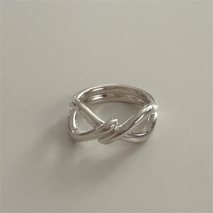 Macro shot of 925 sterling silver knotted ring with high-polish metallic finish
