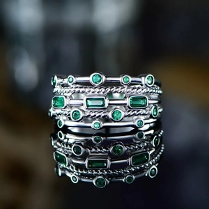 Multi-layer silver ring with emerald green zircon stones and twist band design
