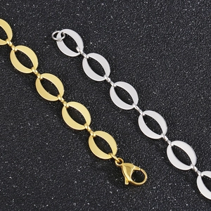 Detail of gold and silver stainless steel oval link chains with lobster clasps