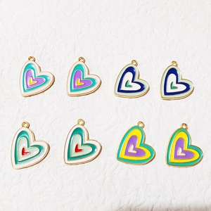 Flat lay macro of eight colorful heart-shaped alloy charms for DIY jewelry making