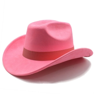 Close-up of bright pink faux suede cowboy hat with brown ribbon trim and rolled brim detail