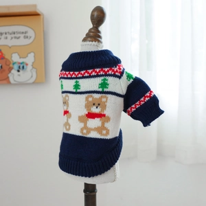 Close-up of navy blue pet knit sweater with cartoon bear and pine tree pattern