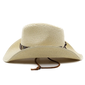 Detailed close-up of woven paper straw texture on a wide brim Western cowboy hat