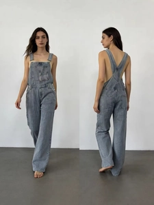 Women's loose denim overalls in light grey with wide leg cut and adjustable straps