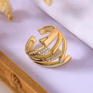 Detail of layered gold copper ring with micro-set zircon stones in decorative box