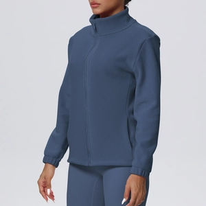 Close-up of greyish blue fleece jacket featuring a high collar and secure side pockets