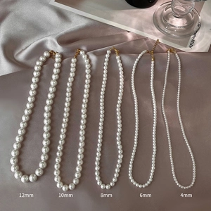 Comparison showing pearl necklaces in five sizes from 4mm up to 12mm on grey satin