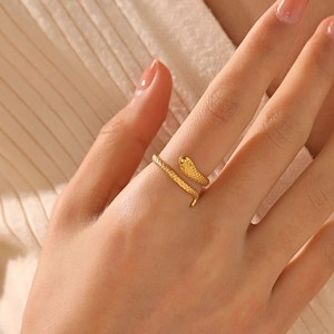 Snake shaped 18K gold plated stainless steel adjustable ring shown on a model's hand