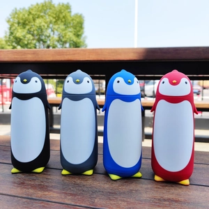 Outdoor wood table with penguin vacuum flasks in black, grey, blue and red colors