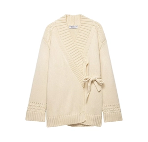 Detailed view of cream knit cardigan with wrap tie waist and hollow out sleeve texture