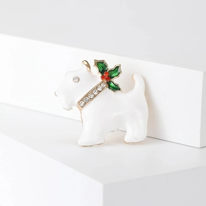 Detail of white enamel Christmas Scottish Terrier brooch with gold trim and rhinestones