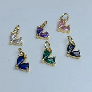 Detailed top view of gold heart pendants with colorful zircon in six vibrant shades