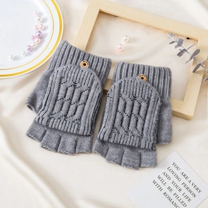 Detail of grey knitted flip top fingerless gloves with soft wool texture and button