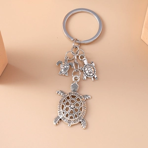 Vintage silver alloy turtle keychain featuring three detailed sea turtle pendants on a ring