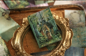 Retro vintage material book with gothic forest cabin illustrations in a golden frame